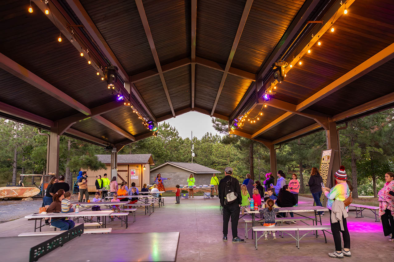 Families gathering beneath the covered pavilion at Jellystone Park Asheboro in North Carolina