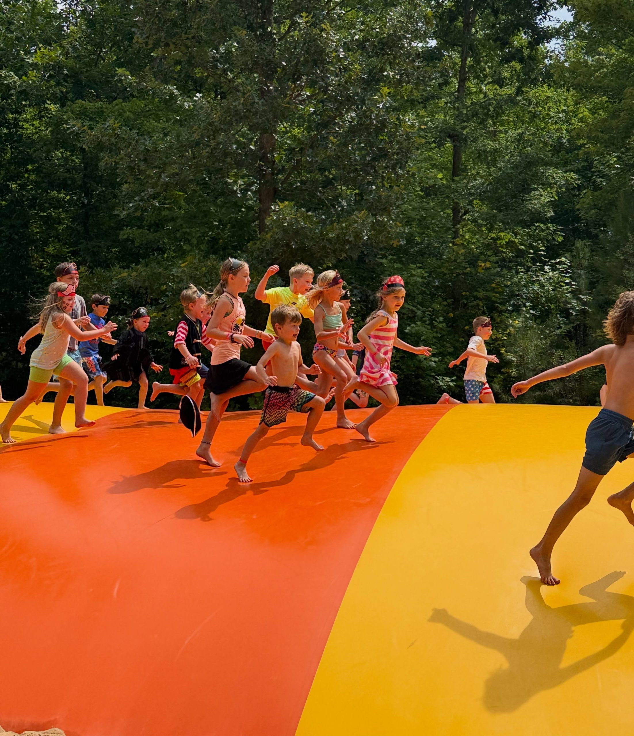 Children playing on the colorful jumping pillow at Jellystone Park Asheboro